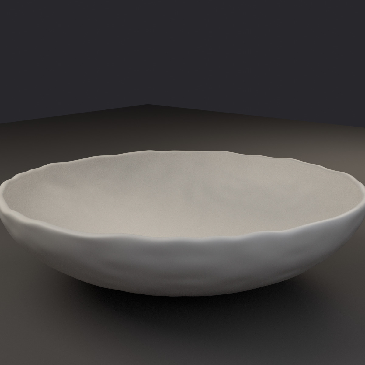 A shallow bone-white ceramic bowl with a slightly imperfect rim, empty.